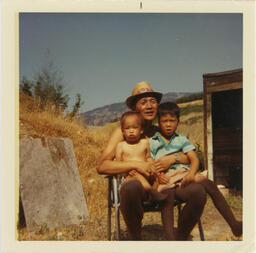 Brian and David sit with their father
