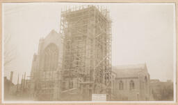 Exterior of church with construction scaffolding surrounding tower