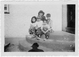 The kids gather on the steps for a photo