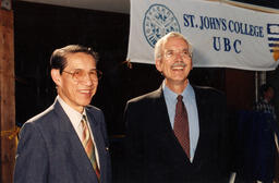 Smiling in front of SJC banner