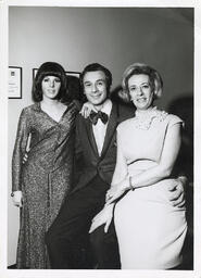 Syd Freedman sitting between two women