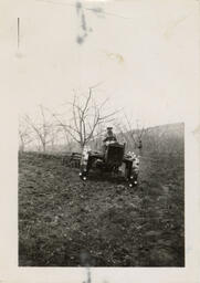 Hideo riding a tractor