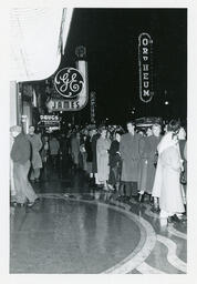 Queue of people in front of a cinema marquee