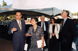 Dedication ceremony attendees engage in discussion