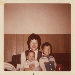Brian and David sit with their mother