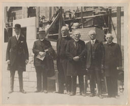 Church building committee in front of construction scaffolding
