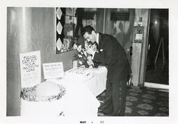 Syd Freedman in front of a table with a cake