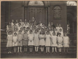 Group photo of young girls in front of the Methodist Church