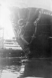 Alaska in harbour showing bow damage [graphic materials]