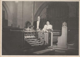 Man and woman posing for a photo at the organ