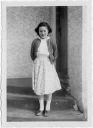 Mary takes her photo on the front steps