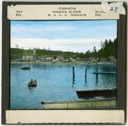 Waterfront view of Alert Bay with Saint Michael's Residential School and Rowboat