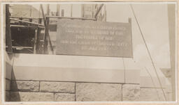 Photo of plaque on exterior of church wall