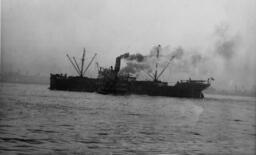 Alamar underway with tug alongside [graphic materials]