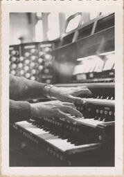 Close up of hands on organ keys