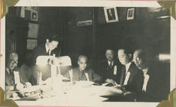 [Teachers at work by lamplight]