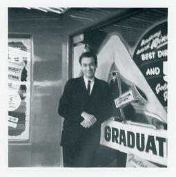 Syd Freedman in front of an advertisement for The Graduate